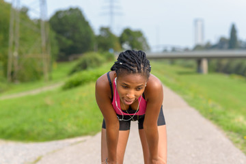 Young African girl taking a break from jogging