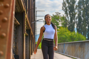 Trendy athletic young African woman laughing