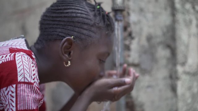 Portrait Video of African Black Girl Drinking Safe Clean Freshwater from Tap (Water for Africa)