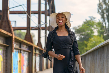 Laughing vivacious African woman in a hat