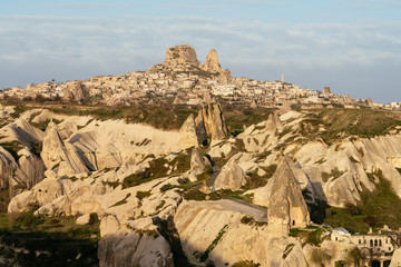 Cappadocia, fairy chimney and Uchisar in background. Anatolia, Turkey