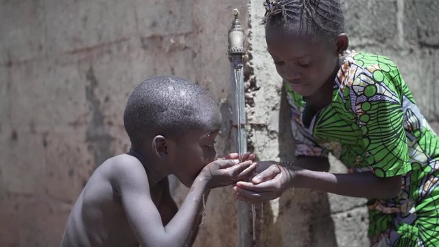 Beautiful Video of African Children Drinking Outdoors Fresh Water from tap