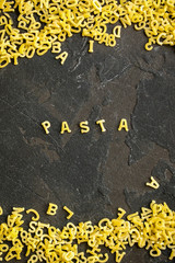 Pasta Alphabet and ingredient for sauce (set of ingredients, raw pasta) serving second course. top food background. copy space