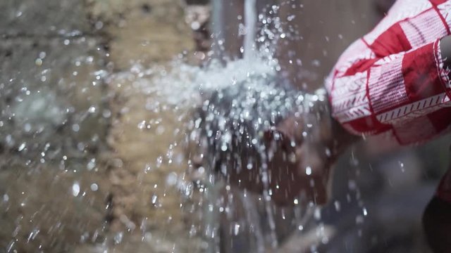 Poverty Symbol, Young African Girl Washing Herself Outdoors in Bamako, Mali