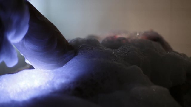 Massage of a beautiful sexy girl's leg under a beautiful soapy foam in Turkish bath Hamam