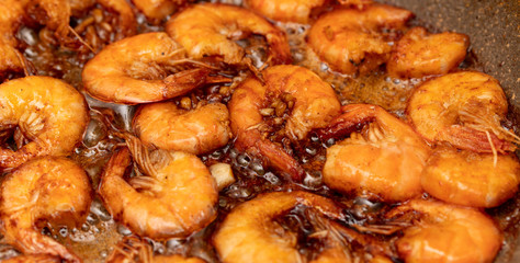 Shrimp fried in a pan in oil