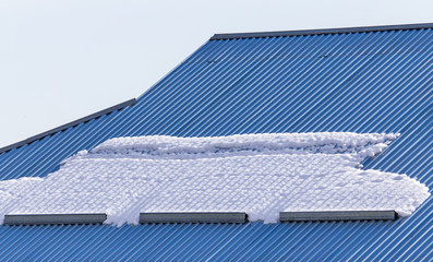 Snow on the roof tiles of the house