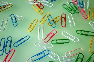 background of colorful paper clips randomly scattered on the table