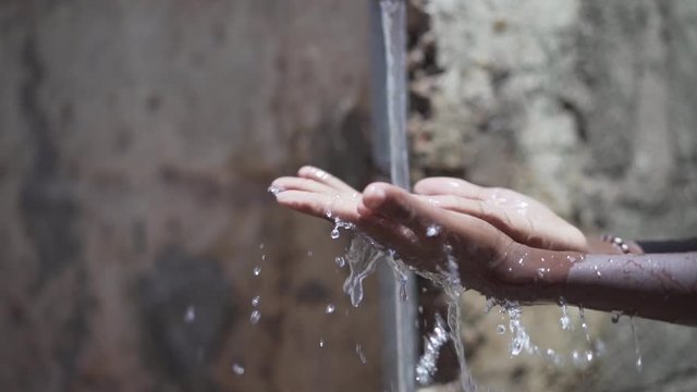 Candid Washing Hands with Fresh Water Climate Change Symbol