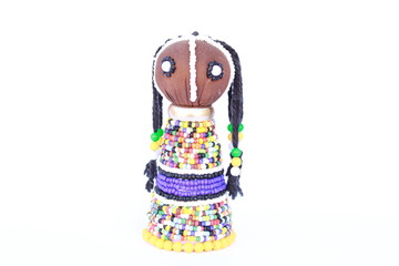 Beaded colorful African doll isolated on a white background