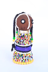 Beaded colorful African doll isolated on a white background