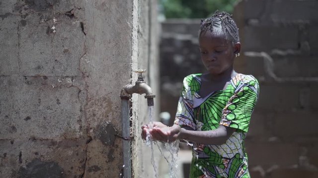 Close Up of African Black Girl Washing Herselft Outdoors