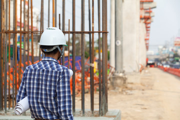 Fototapeta premium workers supervising construction of electric vehicles are looking to plan for construction
