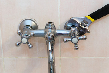 The concept of repair and replacement of the mixer in the bathroom. Old faucet mixer in the bathroom.