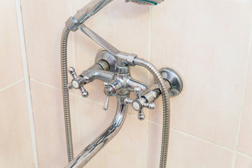 Old faucet the faucet Assembly in the bathroom. Limescale on chrome taps and mixer shower.