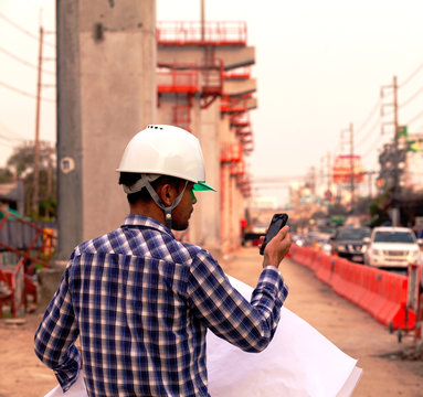engineer checking progress of construction site,engineer working on checking progress of construction site