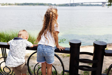 Cute brother and sister in park. Concept of summer,childhood and leisure