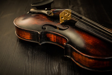Fototapeta premium Close view of old violin and strings in vintage style