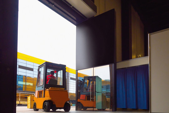 Forklift truck. Diesel forklift. Orange warehouse forklift. Loading and unloading work. Unloading small boxes at the warehouse. Warehouses. Special equipment for warehouses. Sale of special equipment.