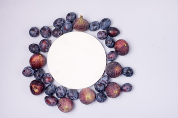 Ripe Blue Plums and Ripe Figs on a Wooden Background Autumn Harvest Fruits Background Copy Space Top View