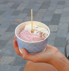 Female hand holds ice cream.