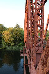 Red suspension bridge across the river