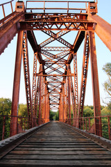 Red suspension bridge across the river