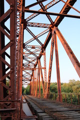 Red suspension bridge across the river