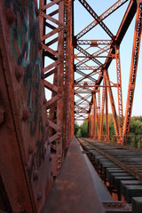 Red suspension bridge across the river