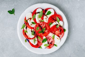 Tomato, basil, mozzarella Caprese salad with balsamic vinegar and olive oil.