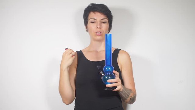 girl smokes medical marijuana through bong