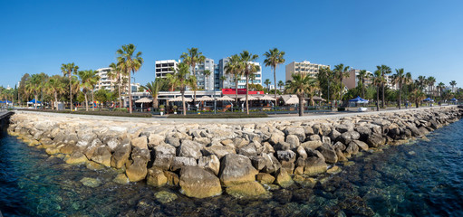 Fototapeta premium Republic of Cyprus. Limassol panorama from the water. Mediterranean coast. Cyprus Hotels. The Seafront Of Limassol. Rest on the Mediterranean. Rocky shore and clear water.