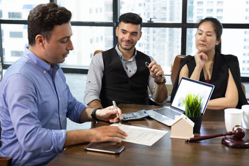 business partners sign two contracts at group meeting, businessman