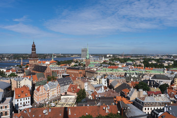 Fototapeta na wymiar Riga, Latvia. Summer. Panoramic view of the city. The streets of the old city aerial view. River, houses, old churches, blue sky. Postcard. Free space for text.