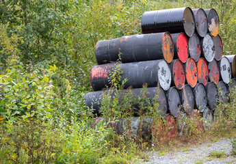 Ecological waste in the nature. Metal barrels in the forest. Waste concept image.