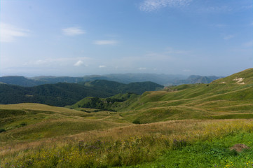 Fototapeta na wymiar Gumbashi pass view in the russian caucasus, green meadow landscape at an altitude of above 2000 m