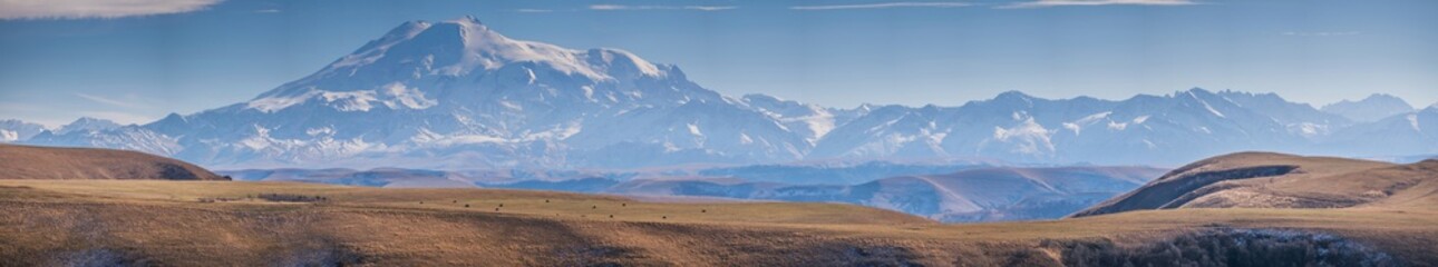 Mount Elbrus, the highest mountain in Europe, located in Caucasus mountains in Russia, panoramic landscape form plateau Bermamyt.