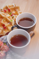Cups of tea with waffles