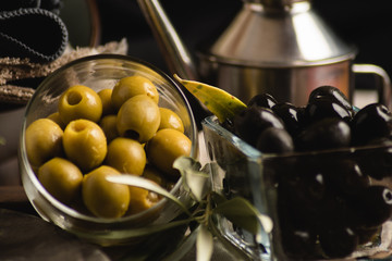 Black and green olives and oilcan close up