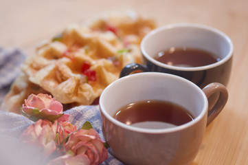 Cups of tea with waffles