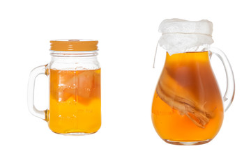Homemade fermented drink Kombucha in a glass jugs. Isolated on white background