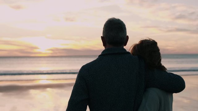 Man and woman standing by the ocean together 