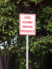 PROHIBITED PARKING ON A STATE HIGHWAY sign attached to a signpost