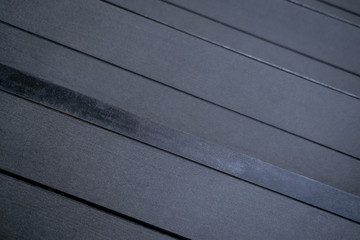 Gray, black hardwood flooring, dark wooden background