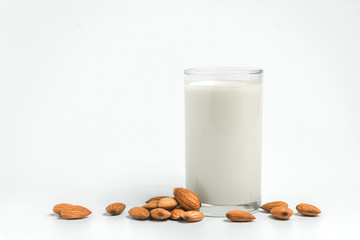 Milk with almonds nut on white background.