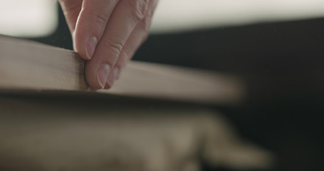 woodworker touching untreated black walnut board