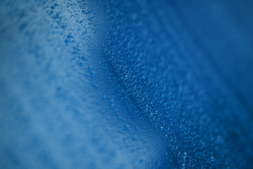 Closeup blue car paint surface with hydrophobic ceramic coating