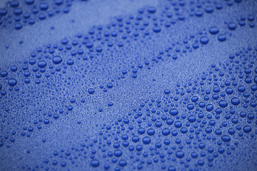 Closeup blue car paint surface with hydrophobic ceramic coating