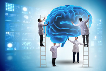 Team of doctors examining human brain