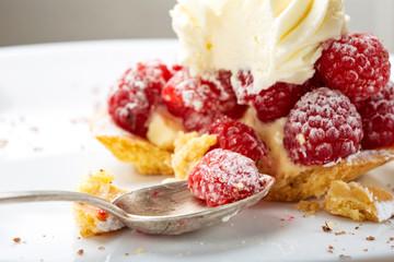 Eating from a baked cake with raspberries